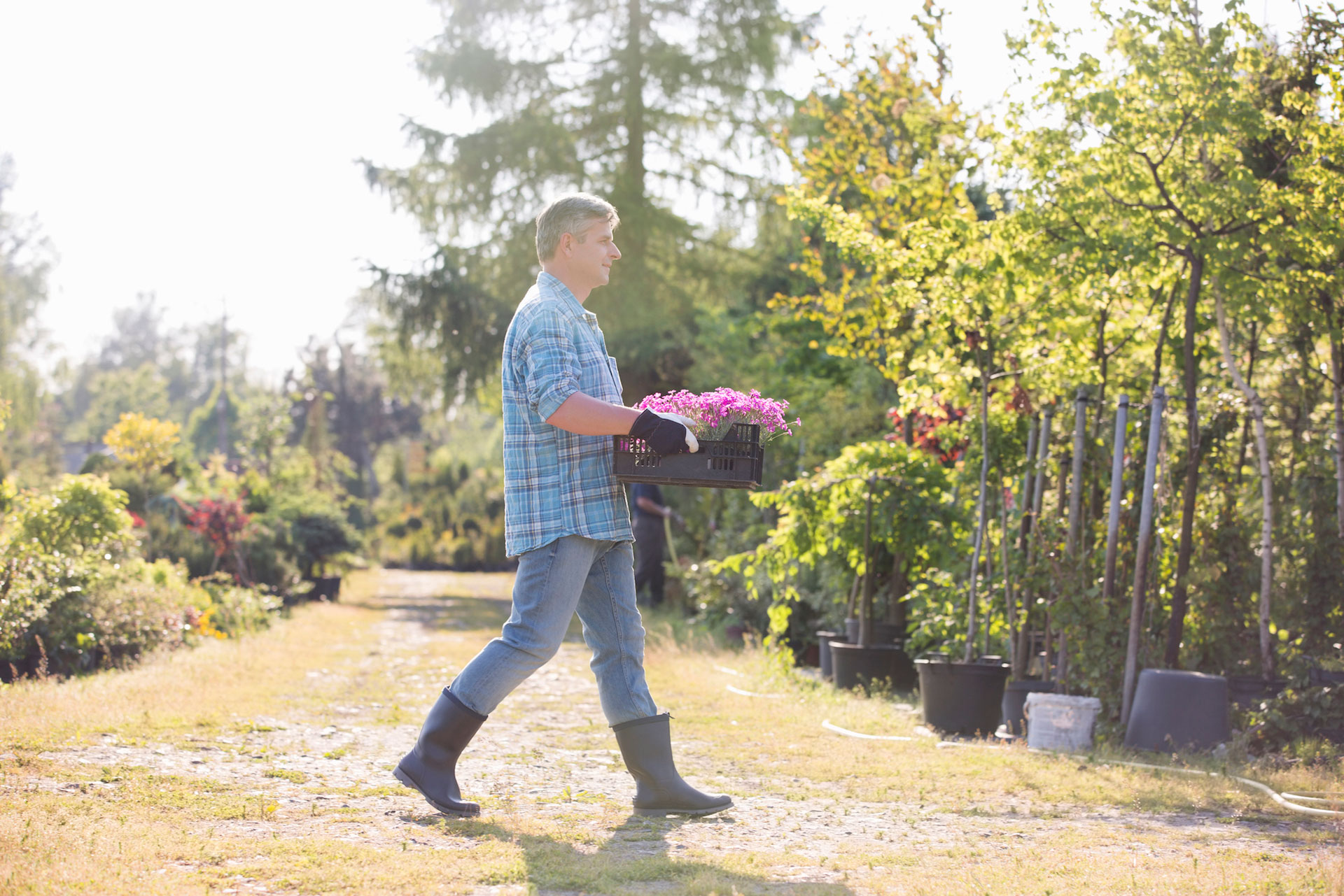 Man outdoors carrying flowers